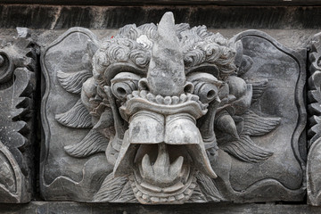 Stone face sculpture in wall at Bali Indonesia