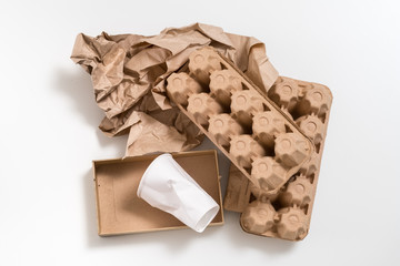 Eco friendly material. Biodegradable waste. Paper boxes and cup arranged on white surface.