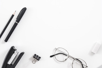 Business routine essentials. Office supplies set. Flat lay of stationery and eyeglasses over white...