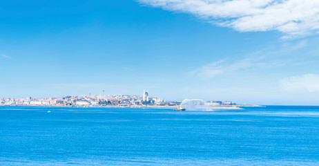 Big boat launching water near a port in A Coruña, Spain. Europe