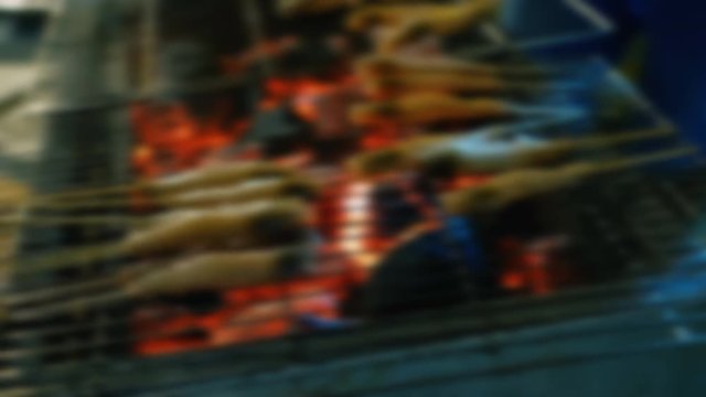 Blurry footage of fresh sea food grilled bbq seafood on charcoal stove for night party. Royalty high-quality free stock footage of grilling fresh prawns or shrimps on the flaming barbecue grill