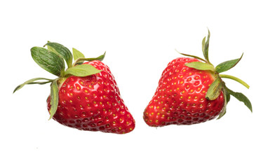 Ripe strawberries on a light background with splashing water close up