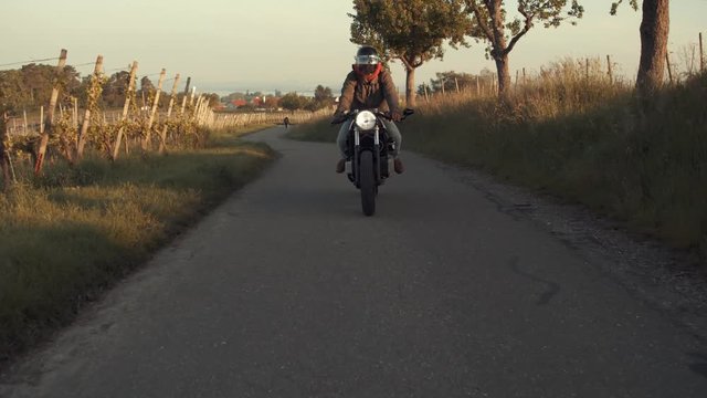 Motorycyclist cuising on country road