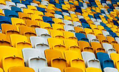 Fototapeta premium Closeup of yellow and blue seats on stadium