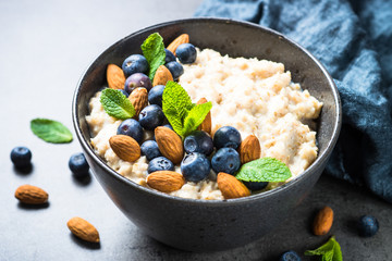 Oatmeal porridge with fresh berries and nuts. 