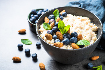 Oatmeal porridge with fresh berries and nuts. 