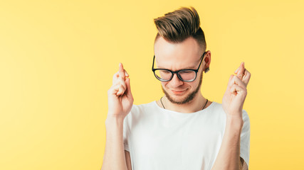 Young man bearded hipster closed eyes crossed fingers. Wish for good luck hope. Job hiring approval win. Waiting dating.