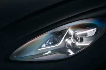 Headlight of modern luxury supercar. Close up detail shot