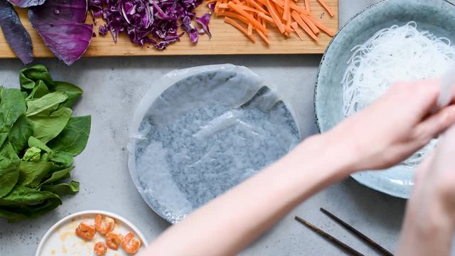 Preparation of vietnamese rice paper rolls with shrimp and vegetables. Real time video recipe cooking