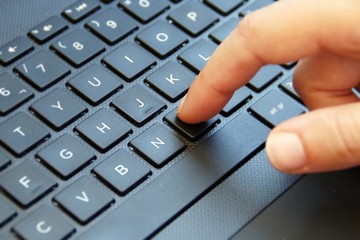 Using the laptop. Girl finger typing.