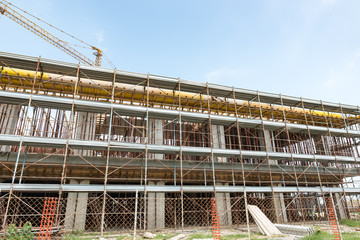 Scaffolds and cranes in a construction site