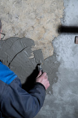 Man plastering a old wall, restoration.