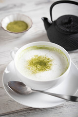 matcha latte on rustic white wood board