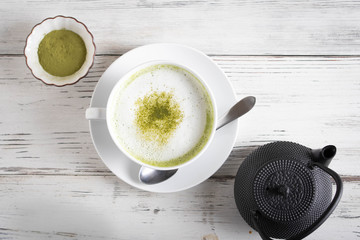 matcha latte on rustic white wood board