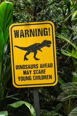 funny notice board show dinosaur in green forest