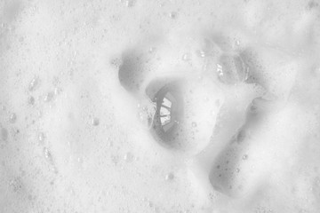 Smooth foam soap form with buubles abstract background. Close up, macro