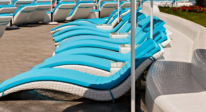 Empty Sunbeds and umbrellas tropical beach resorts