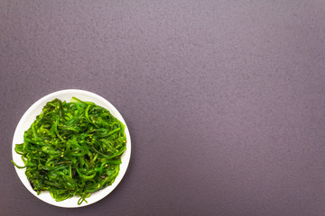 Traditional Japanese Hiyashi Wakame Chuka seaweed salad with sesame seeds.