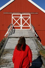 woman in front of a red barn house bridge