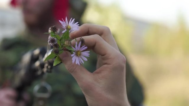 Flower in a machine gun as a symbol for pacifism. Pacifism Concept.