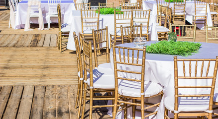 restaurant patio empty ambiance with wooden table and chairs furniture ready for some wedding or birthday event, exterior decoration concept photography 