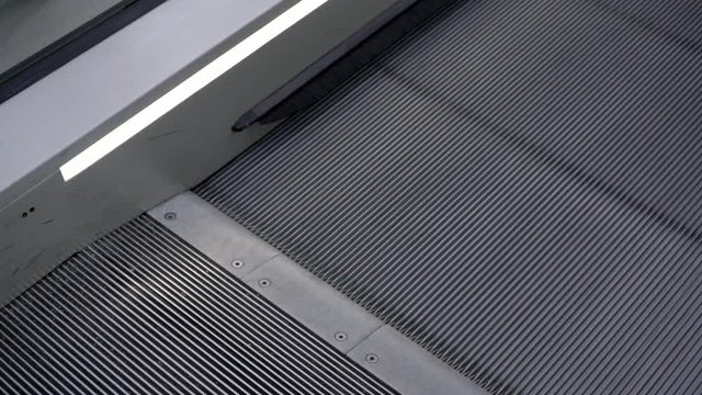 Detail of escalators moving stairs top.