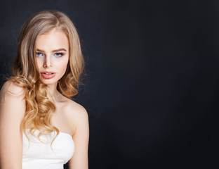 Naklejka premium Beautiful blonde woman portrait. Pretty girl with blonde hair on black background