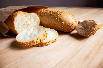 A slice of bread. White bread. Bread wood. Bread on the table. Breor the background. Bread for breakfast. Bakery bread. Bread bake. Bread for food. Bread from wheat. Bread for the morning. Flour Bread