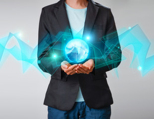 Businessman holding the glowing hologram digital globe. Concepr of business and innovation