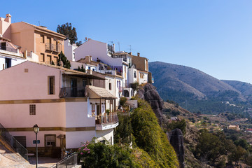 Obraz premium The facades of the white houses of the Spanish old town of Finestrat are built in the mountains.