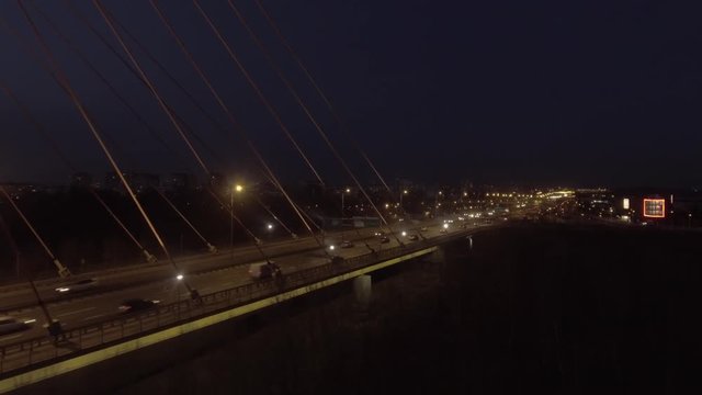 Aerial view of the illuminated night Siekierkowski Bridge crossing the Vistula River in Warsaw Poland.