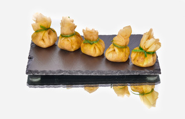 Delicious shrimp dumpling lined up on a black slate