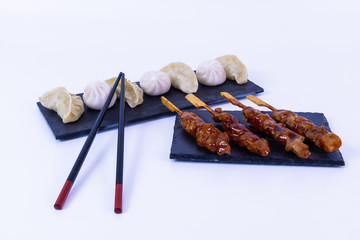 Pot Stickers and pork. Asian food. White background
