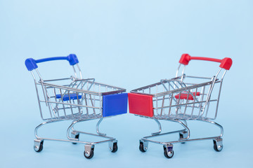 Empty grocery carts on wheels on a blue background