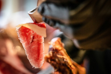 cutting and serving Spanish Iberian ham