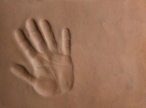 Hand Print Silhouette In Clay Soil.  Hand Print Pattern In Natural Clay Background.