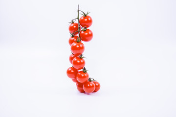 Red cherry tomatoes close-up white background. Fresh ripe red cherry tomatoes close-up on white background