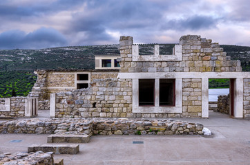 Knossos Palace, Crete / Greece. Archaeological site of Knossos in Heraklion at sunset. Cloudy sky