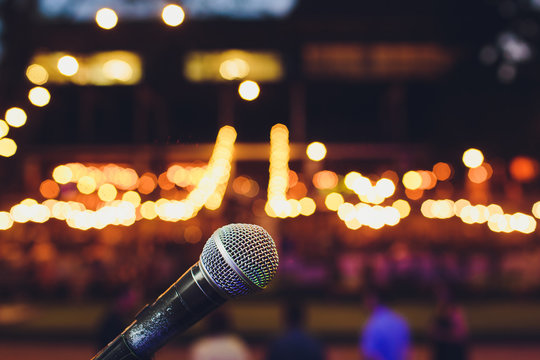 Microphone On A Stand Up Comedy Stage With Colorful Bokeh , High Contrast Image.