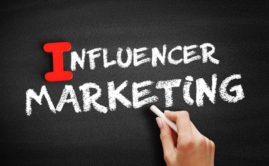 Fototapeta premium Influencer Marketing text on blackboard, business concept background