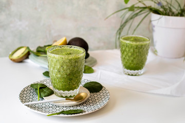 Healthy green smoothie - spinach, avocado and kiwi apple with lemon juice. Super food, detox and healthy food.
