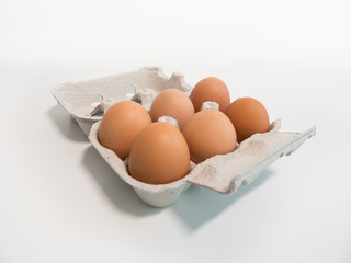 Six fresh eggs in a carton.