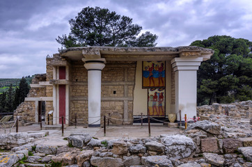 Knossos Palace, Crete / Greece. South Propylaeum restored building with the two frescoes at the archaeological site of Knossos in Heraklion. Sunset, cloudy sky
