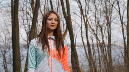 Portrait of the sporty girl in sportswear in a forest.