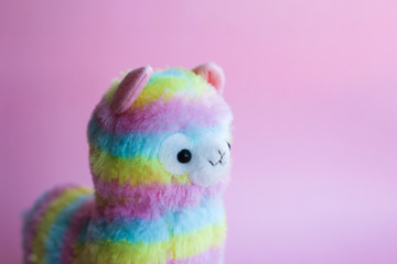 colorful lamp - children's toy, souvenir. beautiful rainbow colors. on a pink background. place for text.