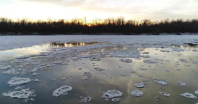 River pancake ice aerial moving accross