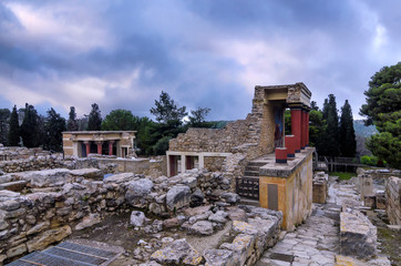 Knossos Palace, Crete / Greece. Restored North Entrance with charging bull fresco at the archaeological site of Knossos. North Lustral Basin room in the background. Sunset, cloudy sky