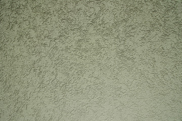 Green plastered wall in sunlight. Modern building materials for