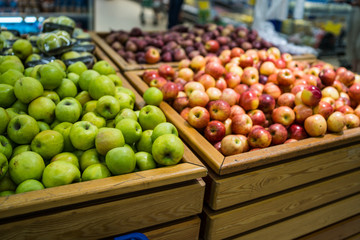 Ripe apple in wooden box Fresh striped apples in wooden box with straw