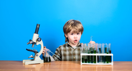 Alchemy. Chemistry. Science. Experiment. Education. Study. Surprised boy working with microscope...
